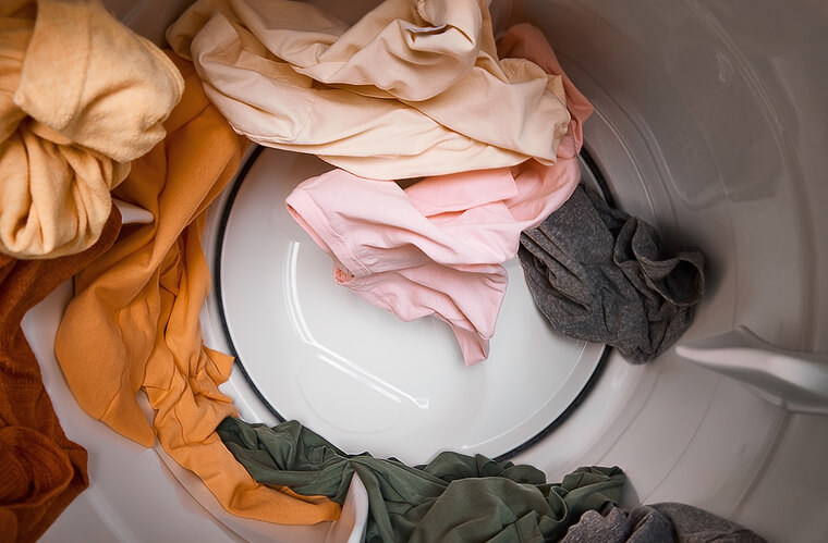 Clothes tumbling inside of a Whirlpool® Dryer