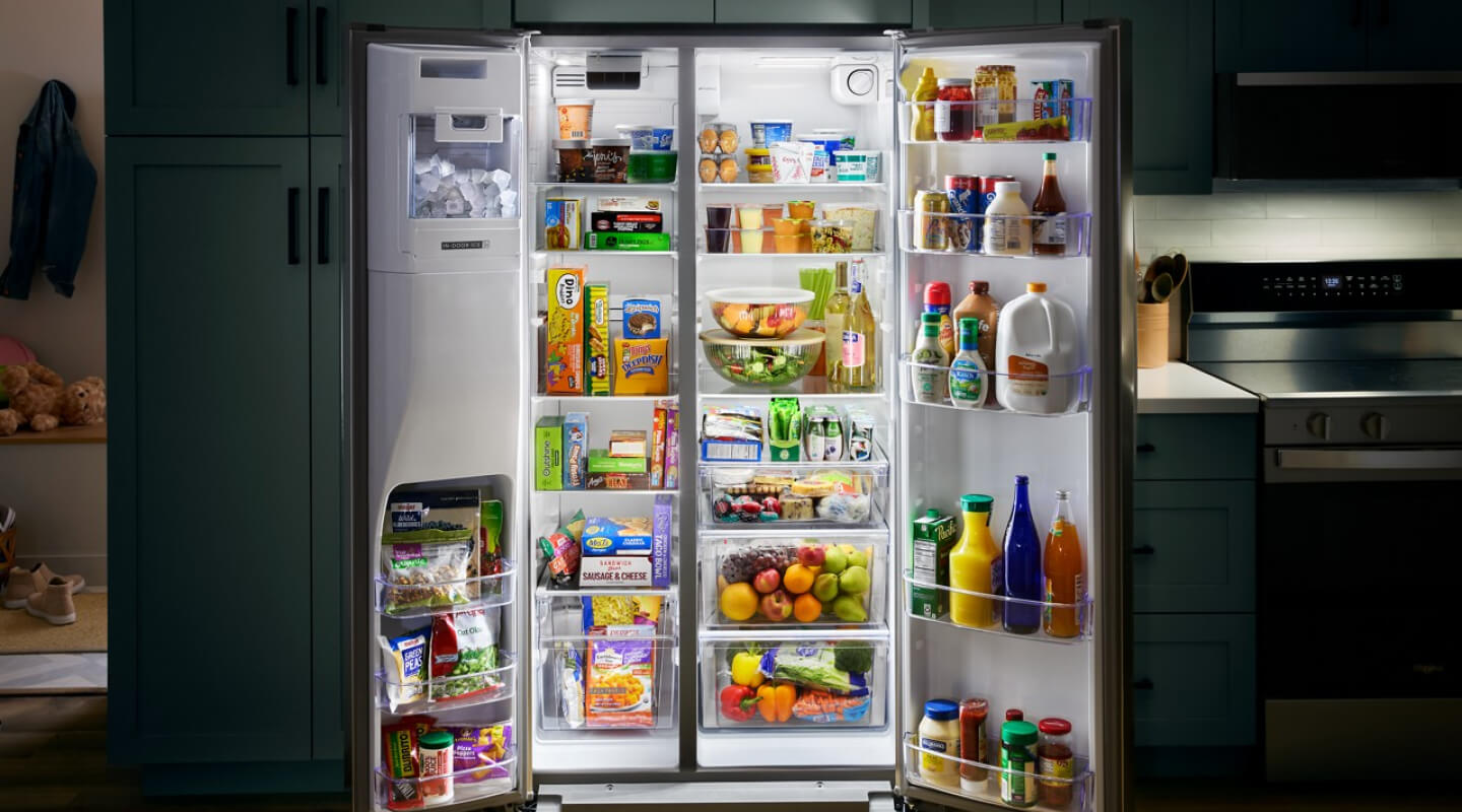 Open side-by-side refrigerator stocked with fresh and frozen foods