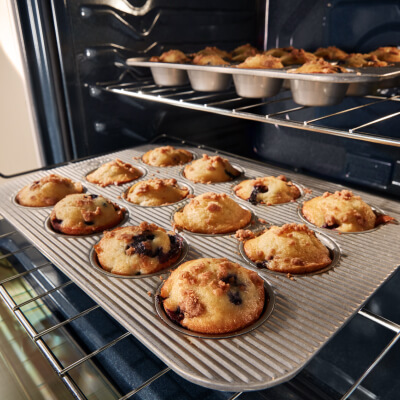 Muffin tin being pulled out of an oven