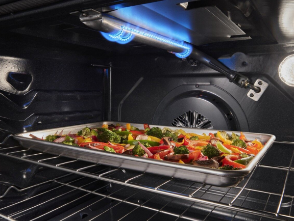 Sheet pan of roasted vegetables under a broiler element Sheet pan of roasted vegetables under a broiler element