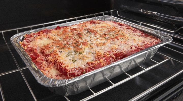 Tray of lasagna in an oven Tray of lasagna in an oven
