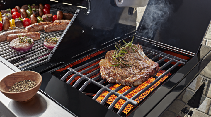Various meats and vegetables cooking on a grill Various meats and vegetables cooking on a grill