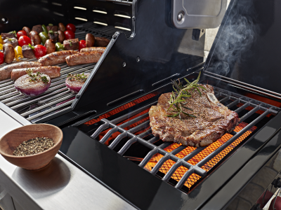 Various meats and vegetables cooking on a grill Various meats and vegetables cooking on a grill