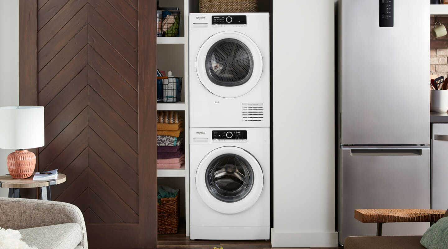 Compact laundry tower behind a sliding closet door