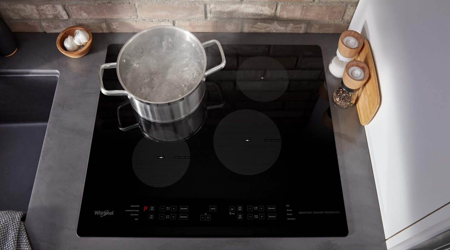 Pot of water boiling on an electric cooktop