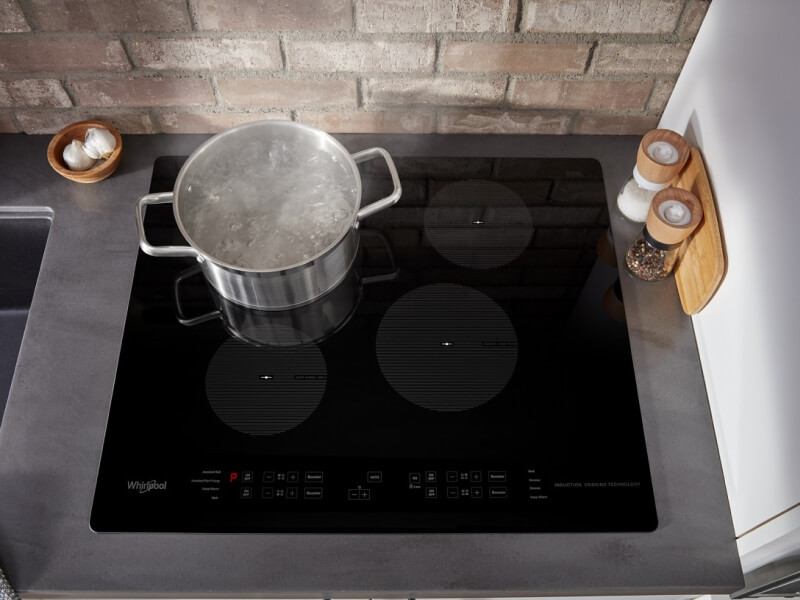 Pot of water boiling on an electric cooktop