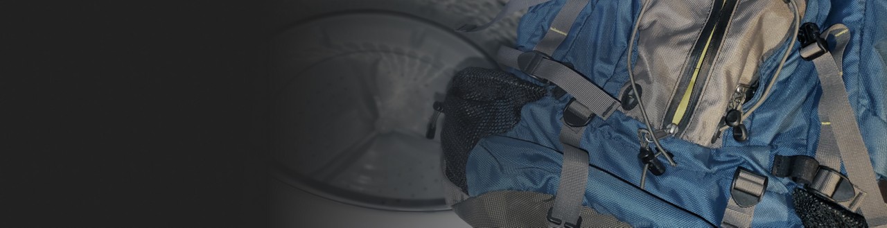 Backpack placed near the interior of a washing machine