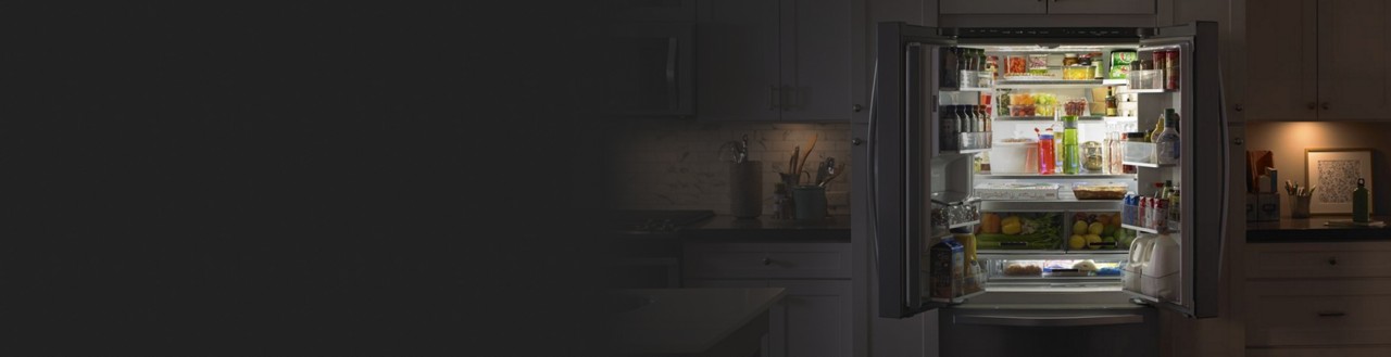 Open French door refrigerator filled with groceries