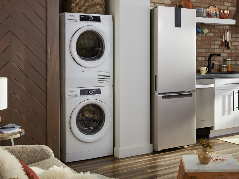 A Whirlpool® stacked washer and dryer in a modern kitchen A Whirlpool® stacked washer and dryer in a modern kitchen