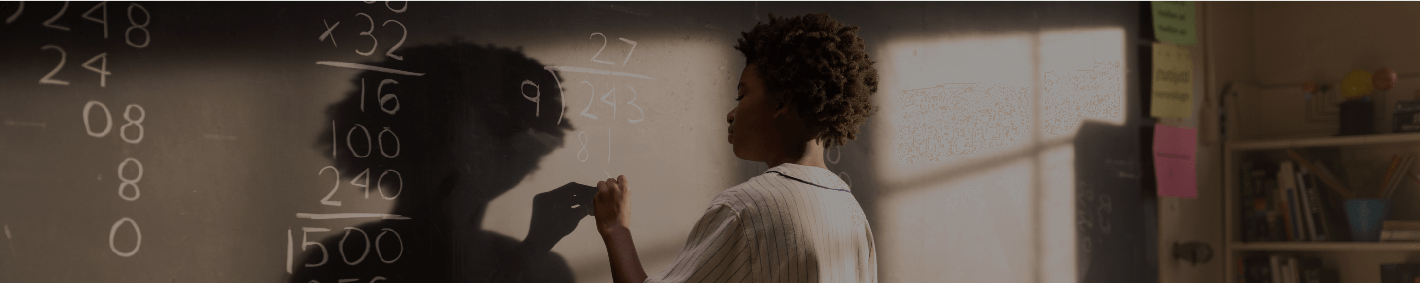 Student writing on a chalkboard