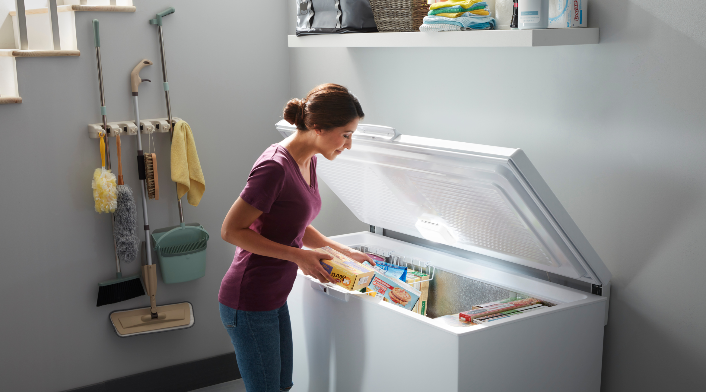 A person placing items into a Whirlpool® Deep Freezer