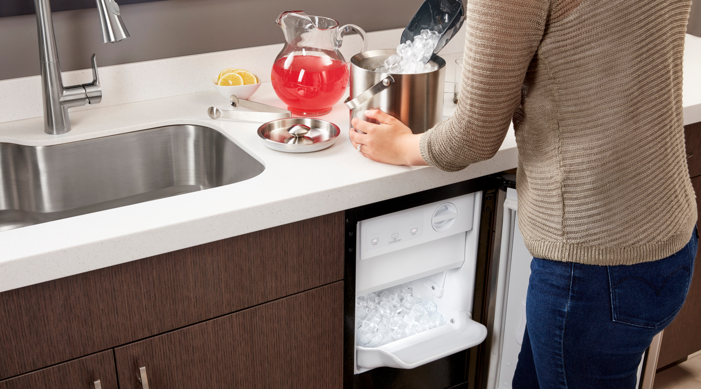 A person putting ice into an ice bucket