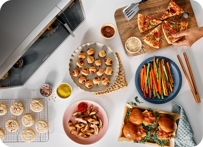 An overhead view of a variety of snack plates next to a countertop microwave