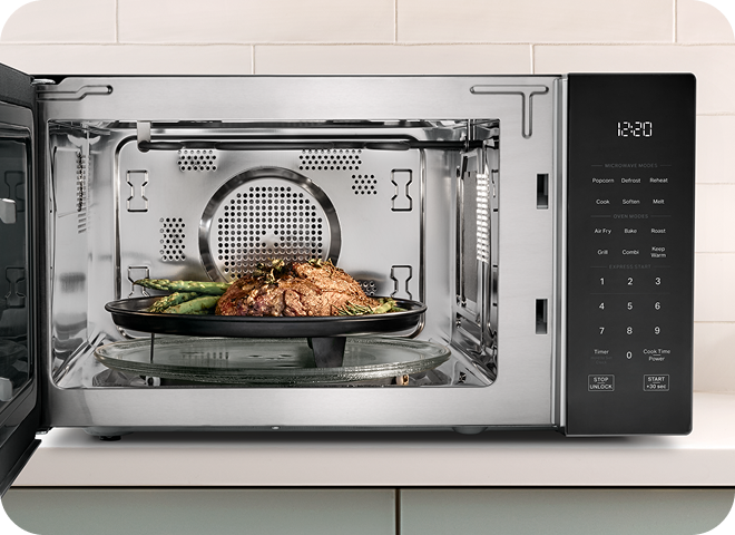 Steak and asparagus grilling inside a Whirlpool® Microwave