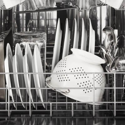 White dishes inside a dishwasher