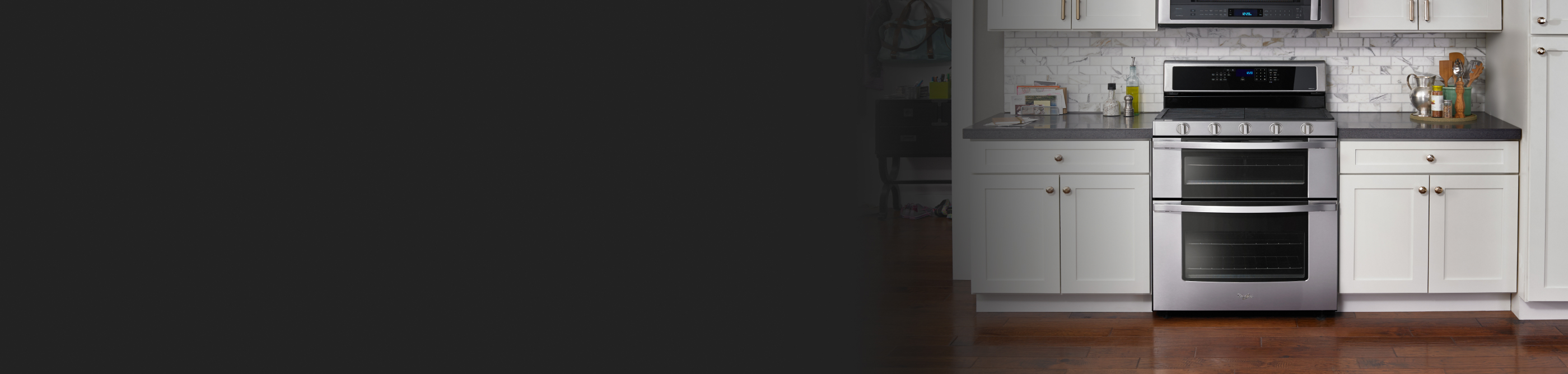 A Whirlpool® range surrounded by white cabinetry.