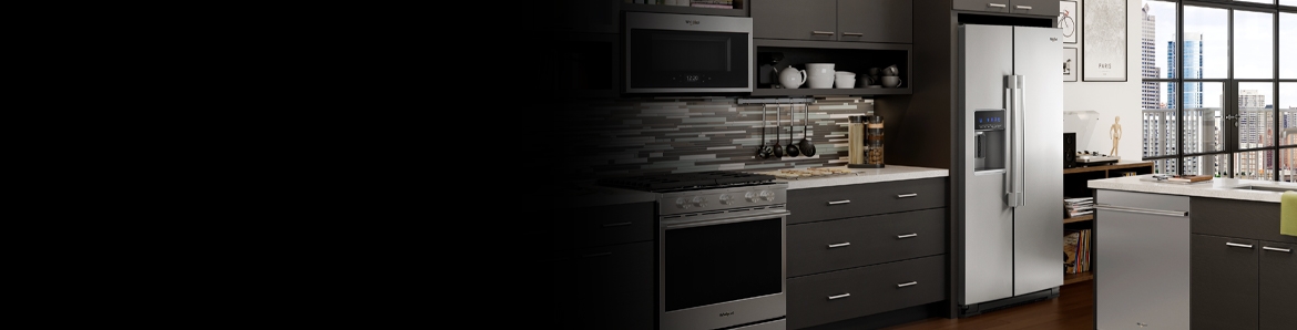 A sleek kitchen featuring a Whirlpool® stainless steel refrigerator.