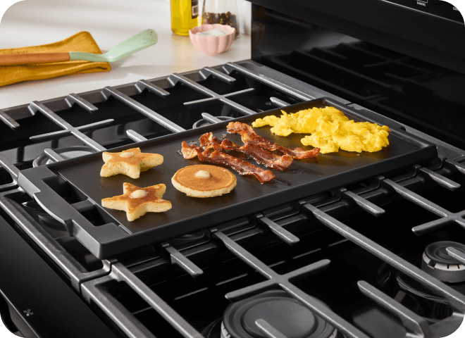 Breakfast items cooking on a griddle on a Whirlpool® Range