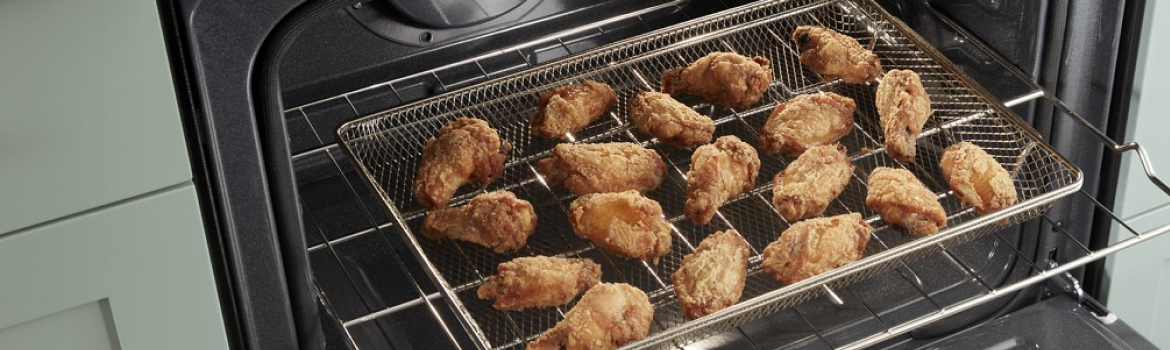 Chicken wings air frying in a Whirlpool® Standard Electric Range