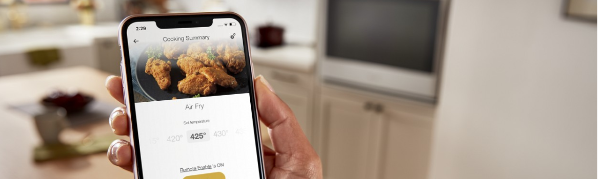 A hand using the Whirlpool® App on a smartphone.