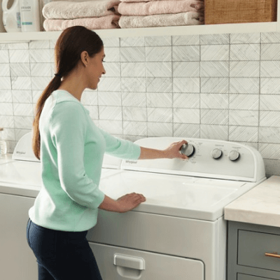 A person selecting settings on a dryer