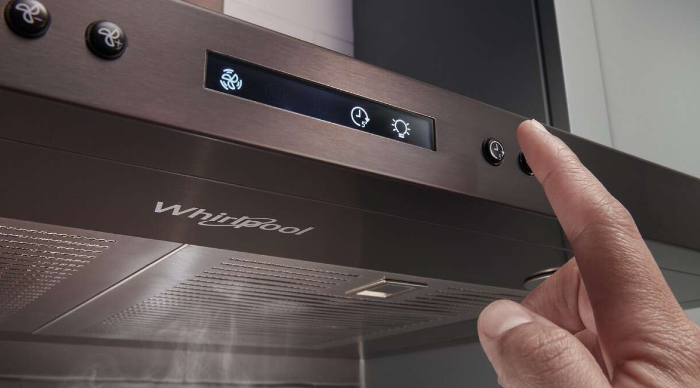 Person selecting a button on a range hood