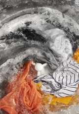 Laundry being washed inside a washing machine