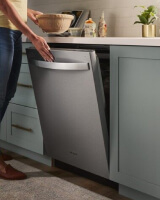 Person closing a top control dishwasher