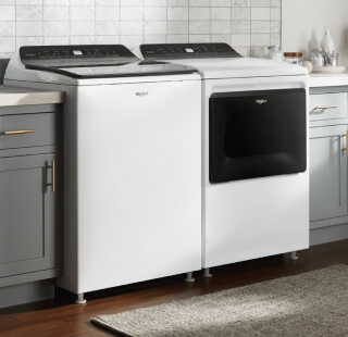 Top load washer and dryer set in a laundry room