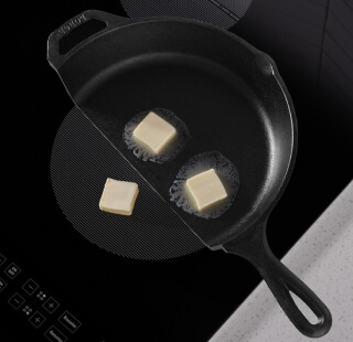 Butter melting in a cast iron pan