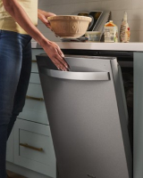 Person opening a top control dishwasher