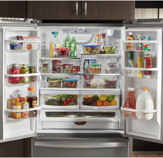 Side-by-side refrigerator doors open with a mix of colorful groceries inside