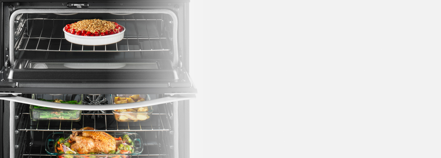 Roasted chicken and a fruit crumble inside a range oven