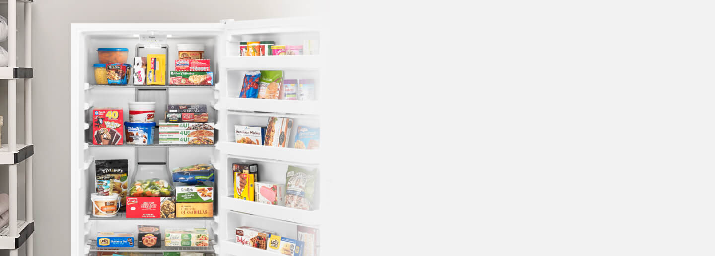 An upright freezer stocked with packaged food