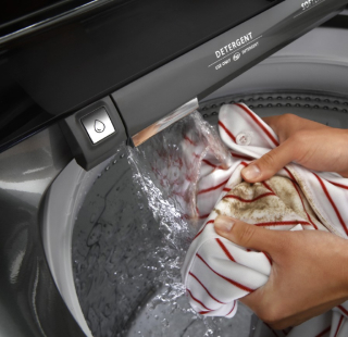 A person pre-treating a towel