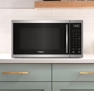 A stainless steel Whirlpool® Microwave on a counter