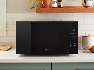 A black Whirlpool® Countertop Microwave