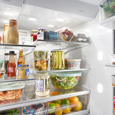 Fresh food and condiments stocked in refrigerator compartment