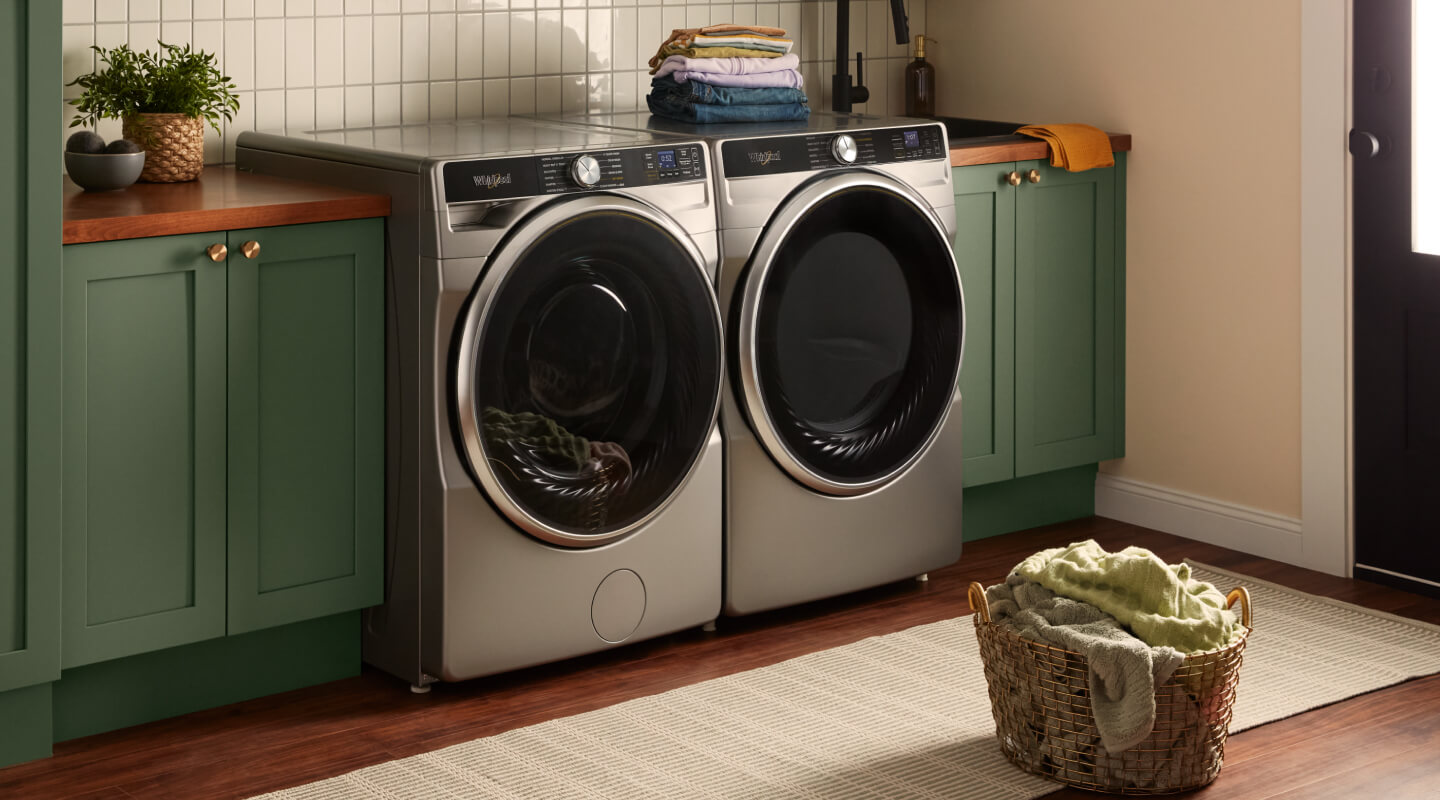 Stainless steel front load washer and dryer in a modern laundry room