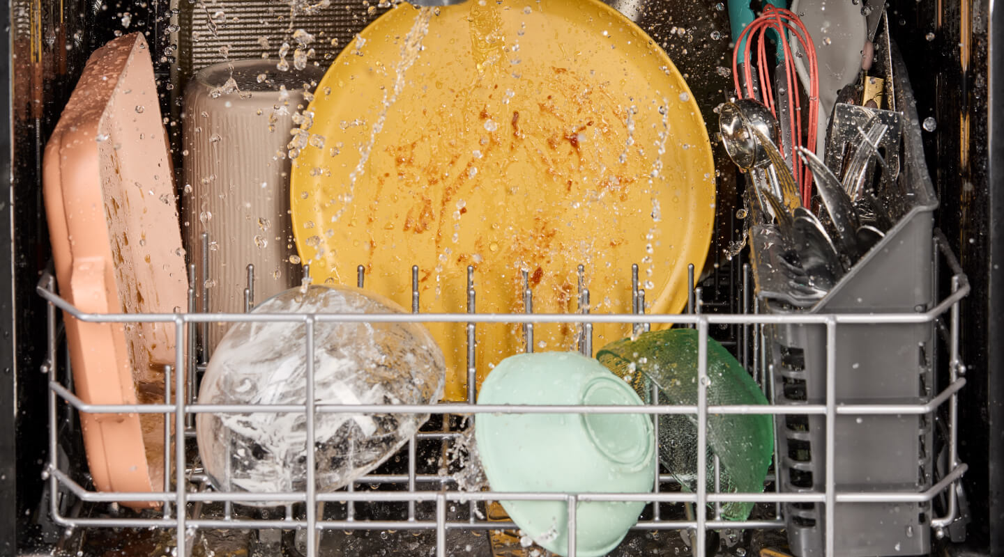  Dirty dishes being washed in a dishwasher