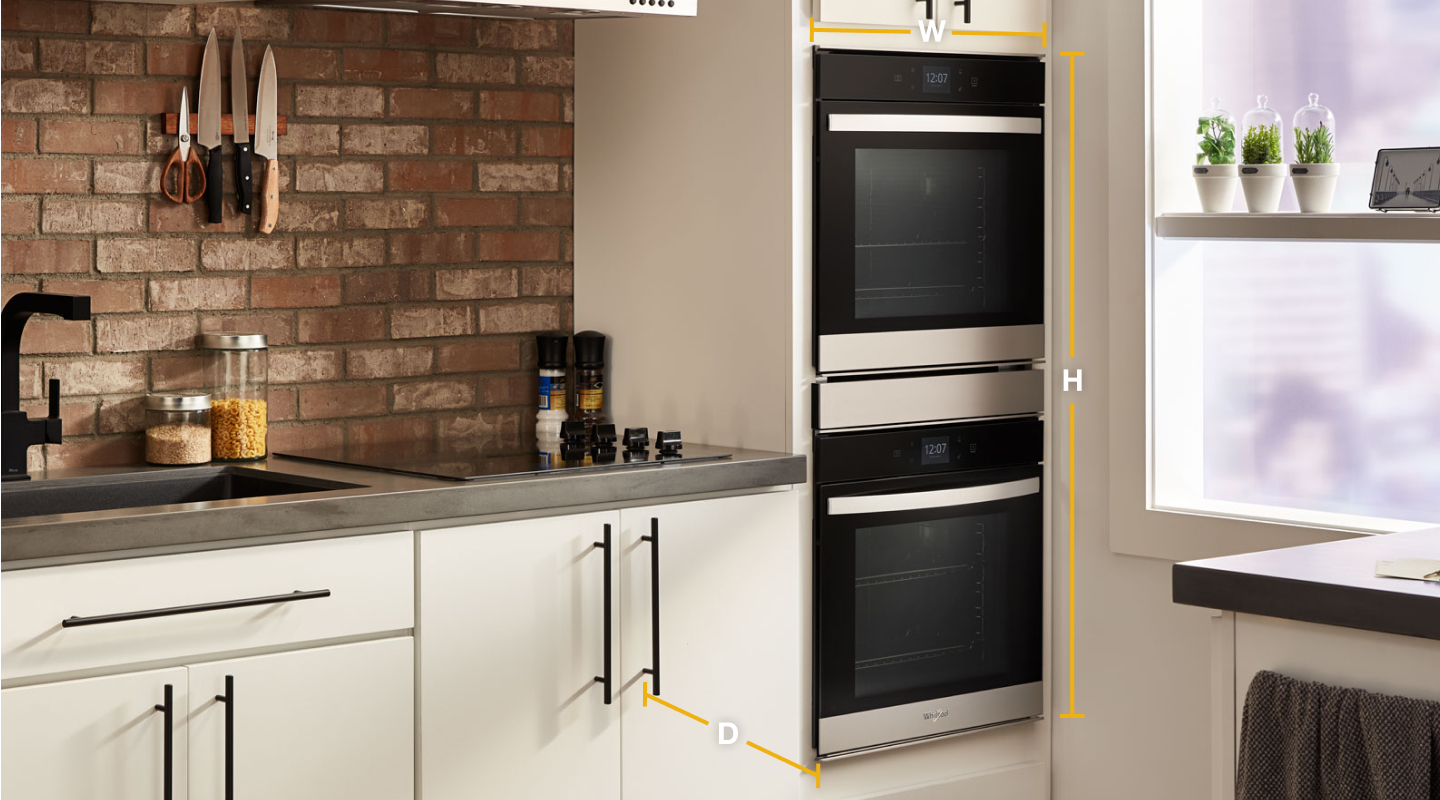 Whirlpool® stainless steel double wall ovens set into white cabinets with diagram of width, height and depth Whirlpool® stainless steel double wall ovens set into white cabinets with diagram of width, height and depth