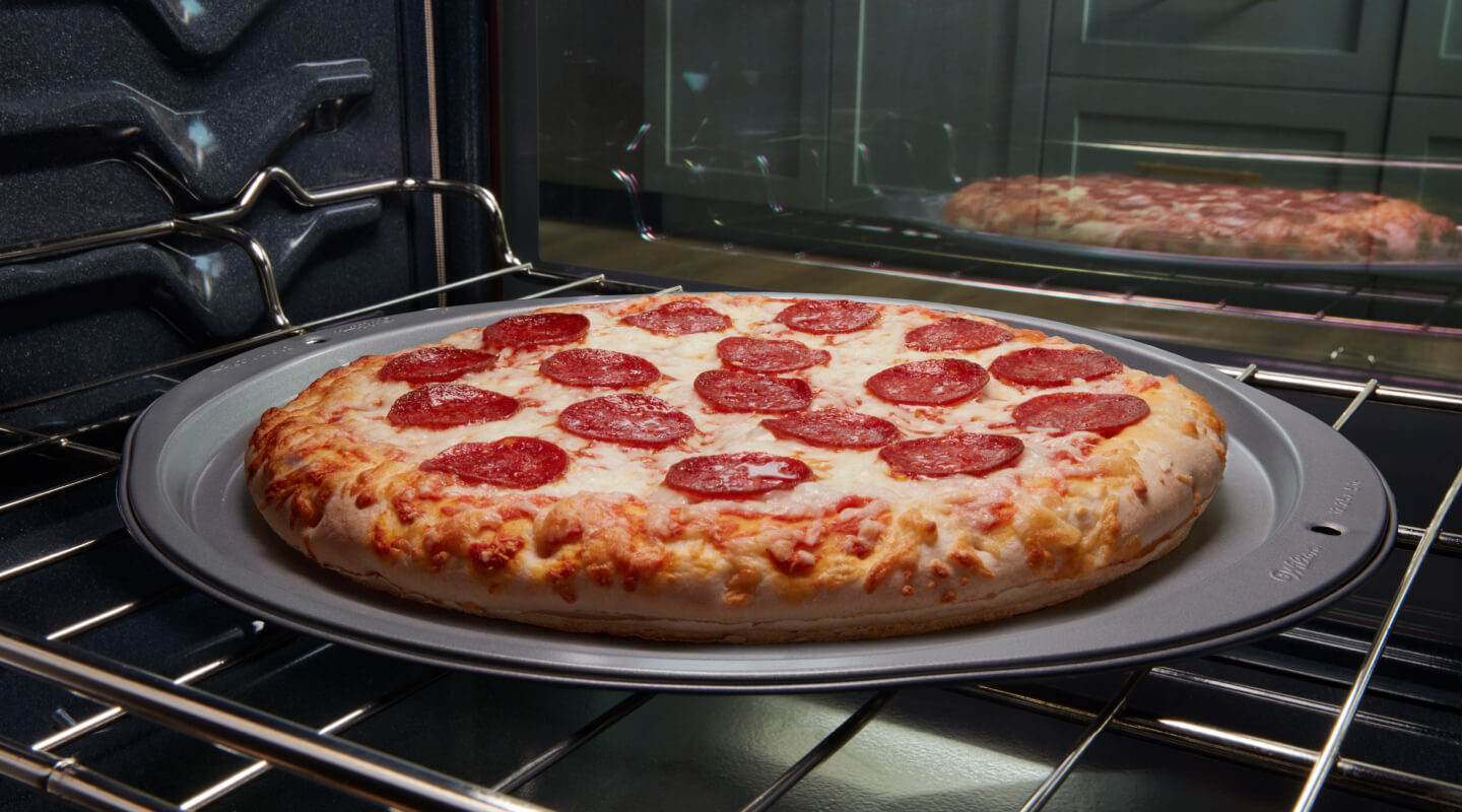 Pepperoni pizza baking in an oven Pepperoni pizza baking in an oven