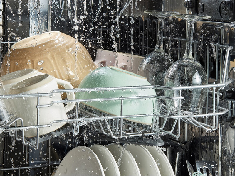 Dishes getting washed in a Whirlpool® Dishwasher