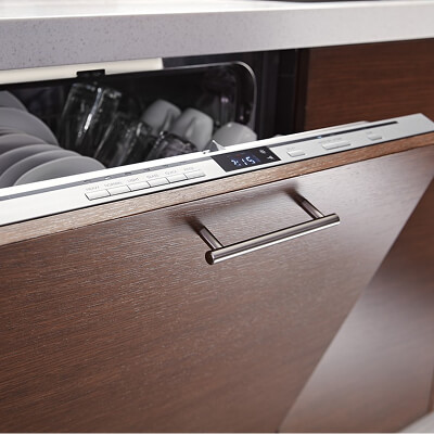 An open panel-ready Whirlpool® dishwasher