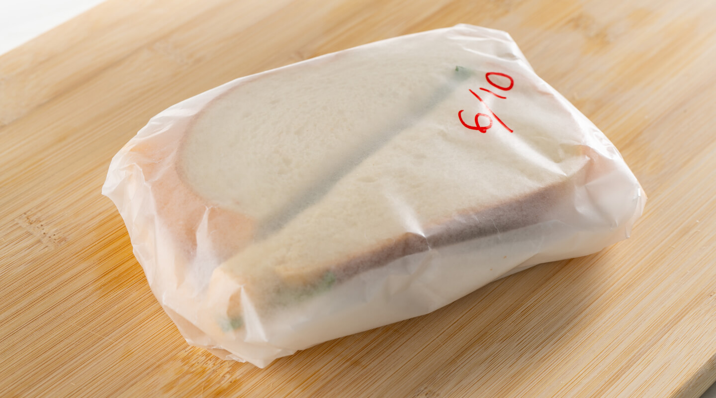 Sandwich wrapped with wax paper Sandwich wrapped with wax paper
