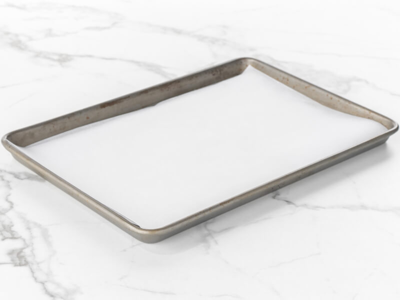 Baking sheet lined with parchment paper Baking sheet lined with parchment paper