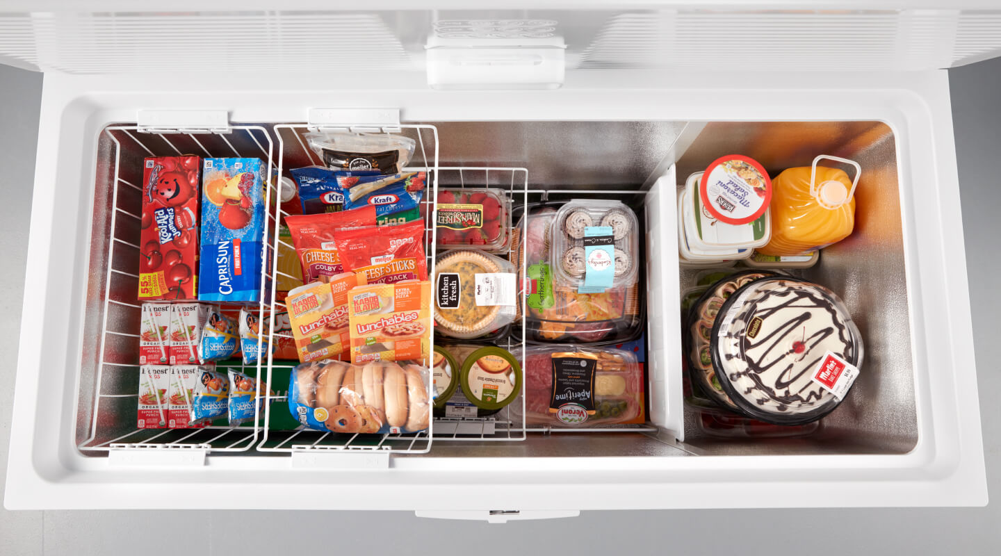 Open chest freezer filled with frozen food