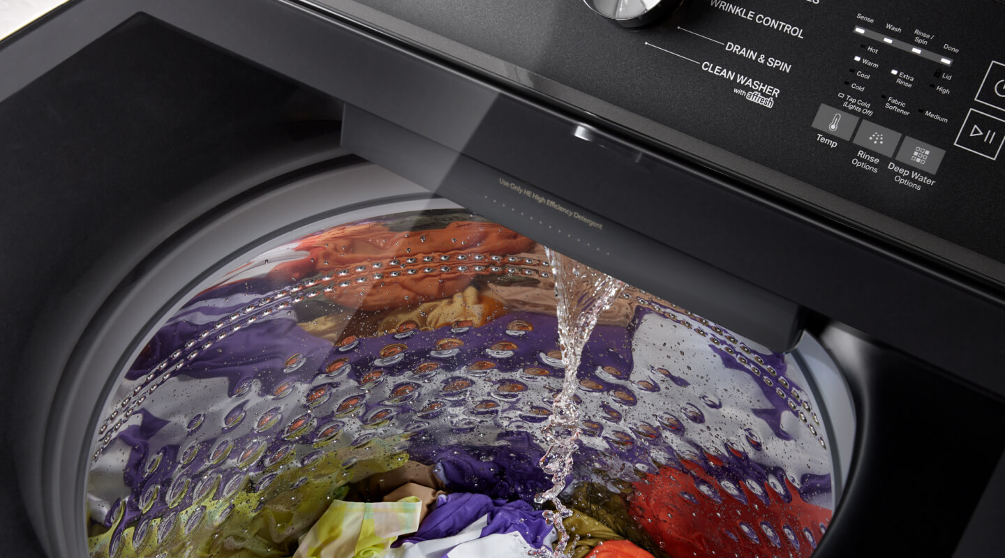 Water pouring into a washing machine Water pouring into a washing machine