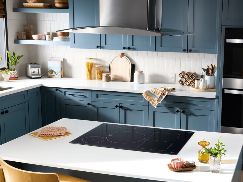 A kitchen with an induction cooktop on an island