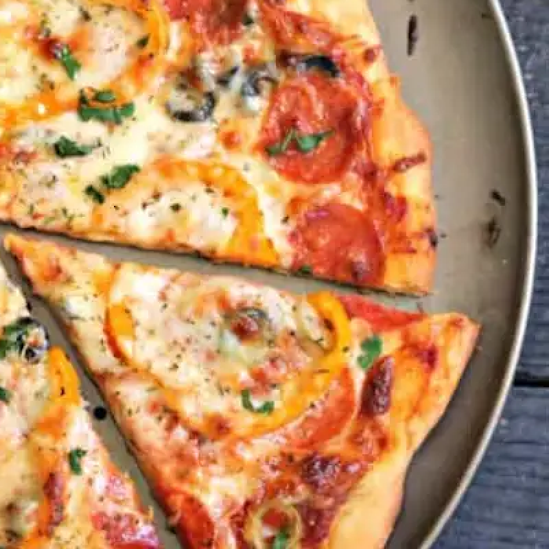 Pizza cut into slices on a pizza pan